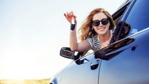 woman holding keys to car