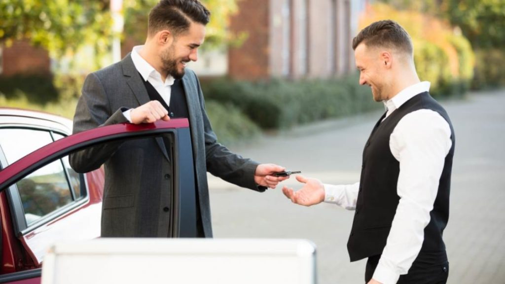 image of man dropping off keys to valet parking attendant